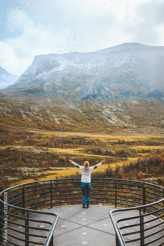 Woman exploring Norway travel outdoor autumn landscape tourist on Vegaskjelet viewpoint aerial view forest and mountains eco tourism