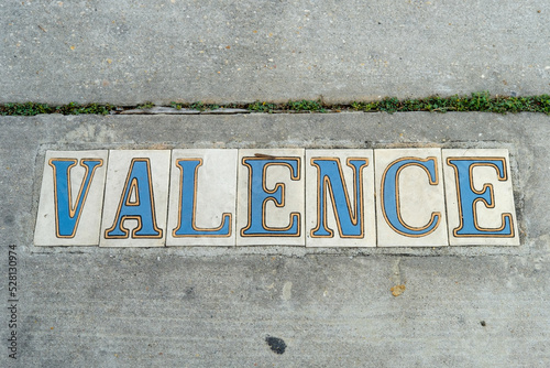 Traditional Valence Street Tile Inlay on Sidewalk in Uptown Neighborhood in New Orleans, Louisiana, USA