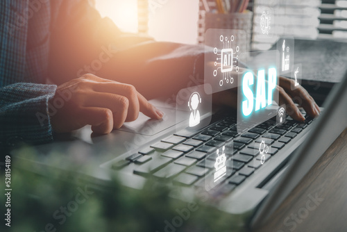 SAP - Business process automation software and management software (SAP), Person hand typing on keyboard with ERP enterprise resources planning system concept on virtual screen.