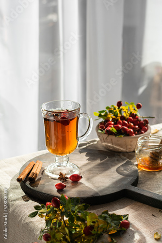 Rosehip hearbal tea on wooden board. Vertical