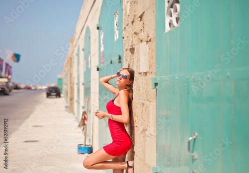 young woman leaning against a wall in the city