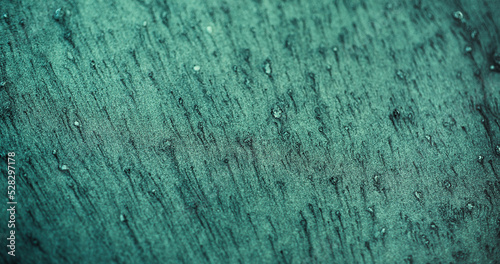 Glitter background. Grain texture. Particles noise. Defocused verdigris green color sand decorative abstract empty space wallpaper.