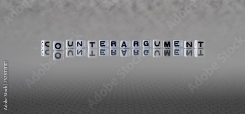 counterargument word or concept represented by black and white letter cubes on a grey horizon background stretching to infinity