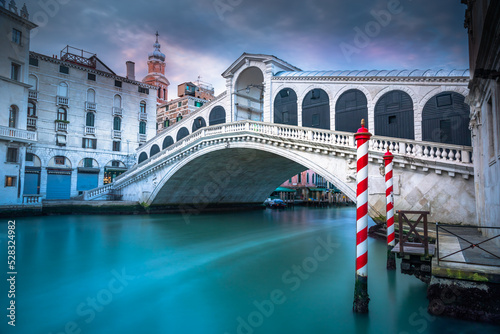 Rialto bridge at peaceful dramatic dawn and Grand Canal, Venice, Italy