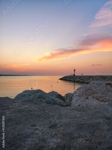 Vertical shot of a pink sunset over the coast of Senigallia, Italy