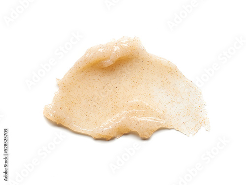 Light beige smear of creamy body scrub isolated on white background.