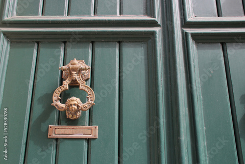 wood door with knocker in ragusa in sicily (italy) 