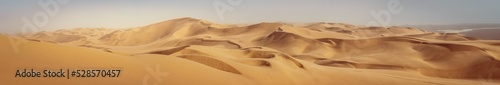 Travel to Africa, adventures, safari or expedition to Namib desert, panoramic view. Wilderness with sandy dunes of Namibia. Panoramic landscape of Sandwich Harbour, view on skyline and high hills.