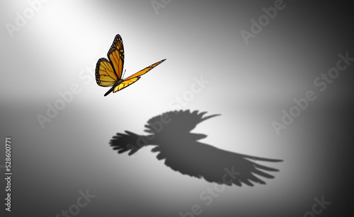 Aspiration for change and ambition for improvement and success as a metaphor for growth and transformation as a butterfly casting a shadow of a flying bird