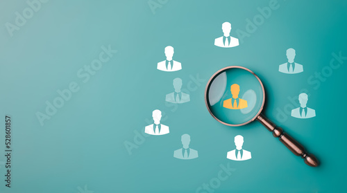 HRM or Human Resource Management, Magnifier glass focus to manager icon which is among staff icons for human development recruitment leadership and customer target group concept...