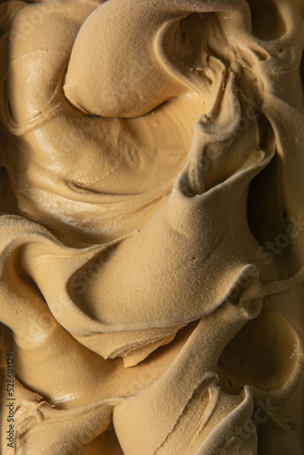 Caramel flavored gelato - full frame detail. Close up of a creamy caramel surface texture of ice cream