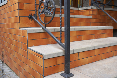 new stairs with brown tiles,stairs with clinker tiles,external stairs made of clinker stone and wrought iron railings