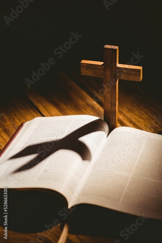 Cross with shadow falling on bible