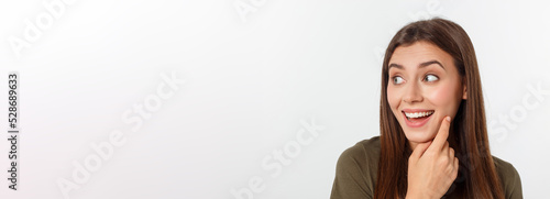 Close-up portrait of surprised beautiful girl holding her head in amazement and open-mouthed. Over white background