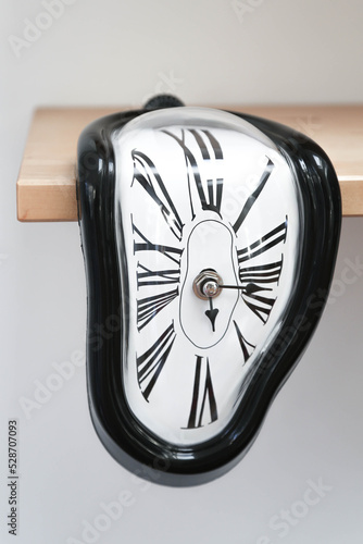 Decorative clocks drain off the shelf. The clock is a symbol of the impermanence of time.