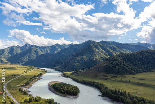 Colorful view of the mountains and the Katun River, with an island in the Altai Mountains, Siberia, Russia. View from the observation deck in the mountains. The concept of recreation and tourism