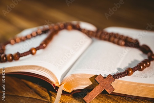 Rosary beads kept on open bible