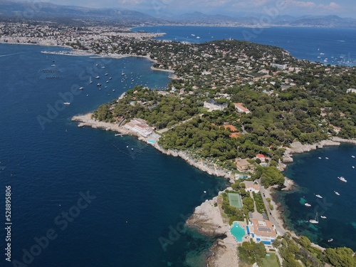 Aerial view of Cap d'Antibes and Billionaire's Bay. Beautiful rocky beach near coastal path on the Cap d'Antibes, Antibes, France. Drone view from above of Côte d’Azur near Juan-les-Pins and Cannes.