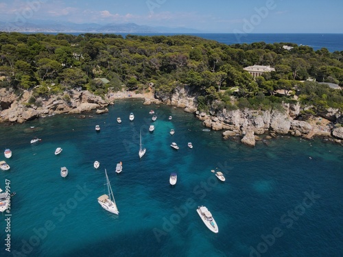 Aerial view of Cap d'Antibes and Billionaire's Bay. Beautiful rocky beach near coastal path on the Cap d'Antibes, Antibes, France. Drone view from above of Côte d’Azur near Juan-les-Pins and Cannes.