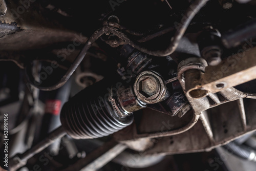 Closeup of a steering rack nut of a car.