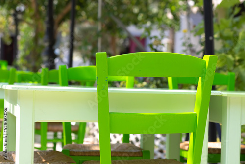 green chair at the glistening white table