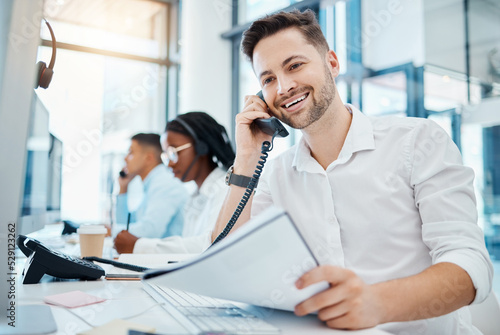 Telemarketing, sales or customer service worker smiling and talking on a telephone selling insurance. Young happy call center agent excited by good news on the phone and working in an office
