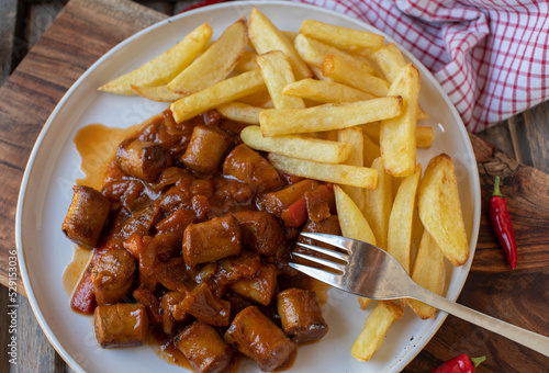 Sausage goulash with french fries on a plate