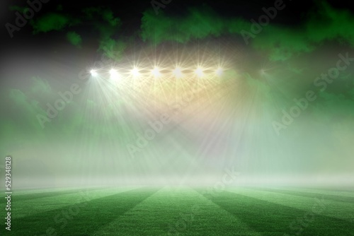 Football pitch under green sky and spotlights
