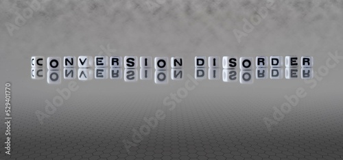 conversion disorder word or concept represented by black and white letter cubes on a grey horizon background stretching to infinity