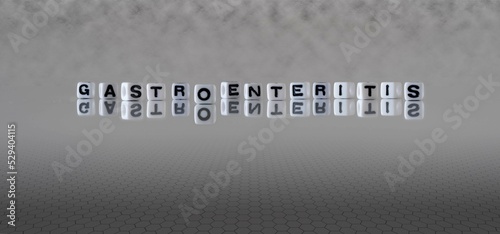 gastroenteritis word or concept represented by black and white letter cubes on a grey horizon background stretching to infinity