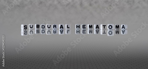 subdural hematoma word or concept represented by black and white letter cubes on a grey horizon background stretching to infinity