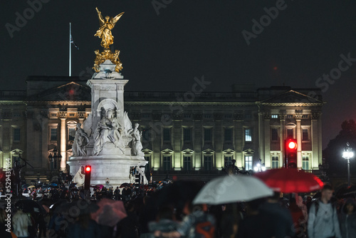 People mourn and bring flowers under the rain outside Buckingham Palace after Queen Elizabeth died
