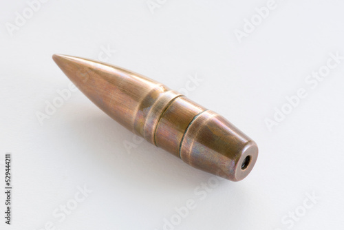 Armour piercing inert round projectile odrnance bullet for the French Hotchkiss 25 mm S.A. Mle 1934 anti-tank gun. Military theme. copper sheathed crimped in the brass cartridge case. Whate background