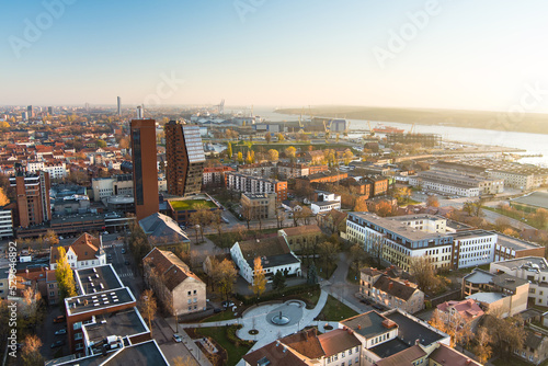 Scenic aerial view of the Old town of Klaipeda, Lithuania in golden evening light. Klaipeda city port area and it's surroundings on autumn day.