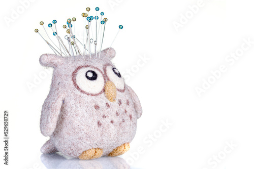 pincushion in the form of an owl on a white background