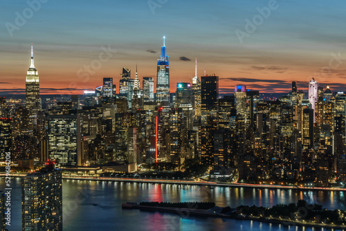 Aerial view of New York city, Empire State Building, Chrysler Building, One Vanderbilt, 30 Rock at sunset and twilight