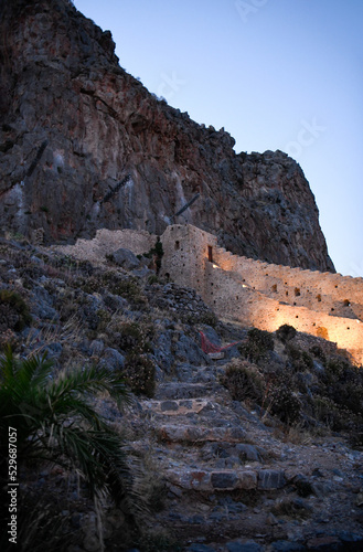 Lit up city wall in soft light of evening in Monemvasia, Greece