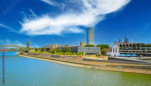 Cologne (Kennedy-Ufer, Deutz, Rheinboulevard), Germany - July 9. 2022: Beautiful skyline, river rhine, Hyatt Regency Hotel, Triangle tower, waterfront boardwalk, Hohenzollern bridge