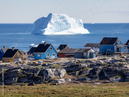 Huge icebergs lining the shores of the charming town of Qeqertarsuaq (formerly Godhavn) on the south coast of Disko Island, Western Greenland.