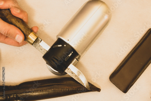 sharpening an antique knife with an electric grinder, high carbon steel