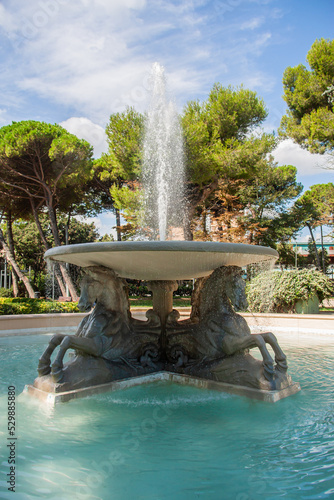 Beautiful Fontana dei Quattro Cavalli in sunny day in Federico Fellini park in Rimini, Italy