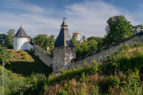 View of the wall of the Holy Dormition Pskov-Pechersk Monastery, the Tower of the Upper Lattices, Tailovskaya tower on a sunny summer day, Pechory, Pskov region, Russia