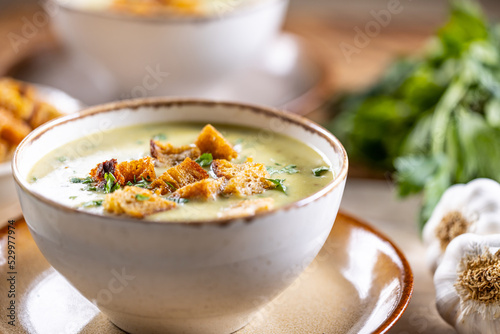Garlic cream soup with bread croutons in bowl