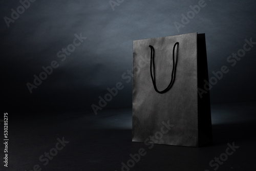 Composition of gray paper shopping bag on gray background