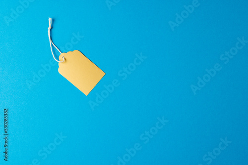 Composition of gift tag with copy space on blue background