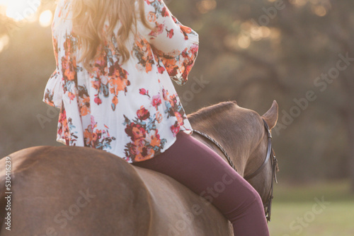 A woman rides her horse bareback. 