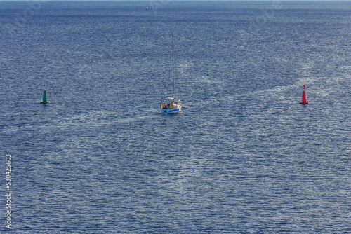 Red and green navigational buoys, starboard and port side buoys on open water