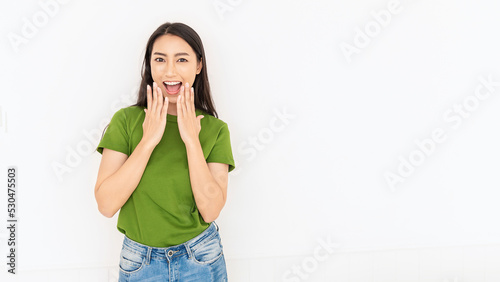 Attractive beautiful positive asian woman. Close up portrait of happy pretty nerd Japanese asia lady girl wearing green t shirt with smiling face isolated on white background. Excited wow young women