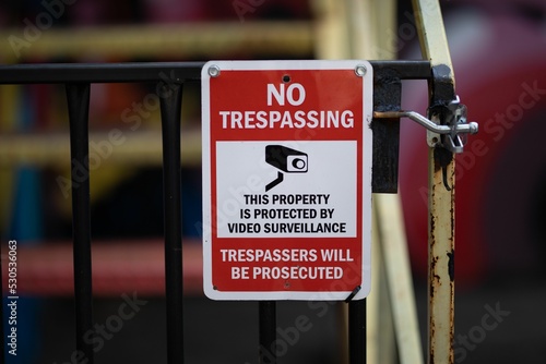 Closeup shot of a no trespassing warning red sign