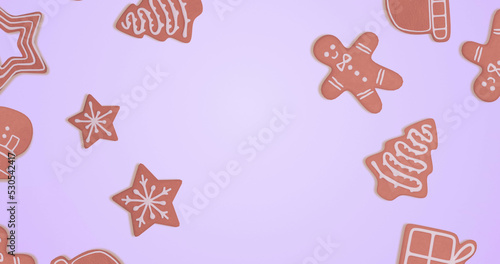 Image of gingerbread falling at christmas over blue background
